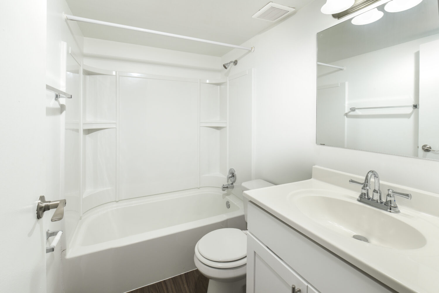 updated bathroom with white vanity and tub