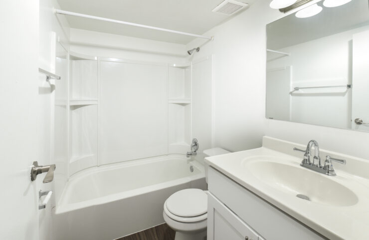 updated bathroom with white vanity and tub