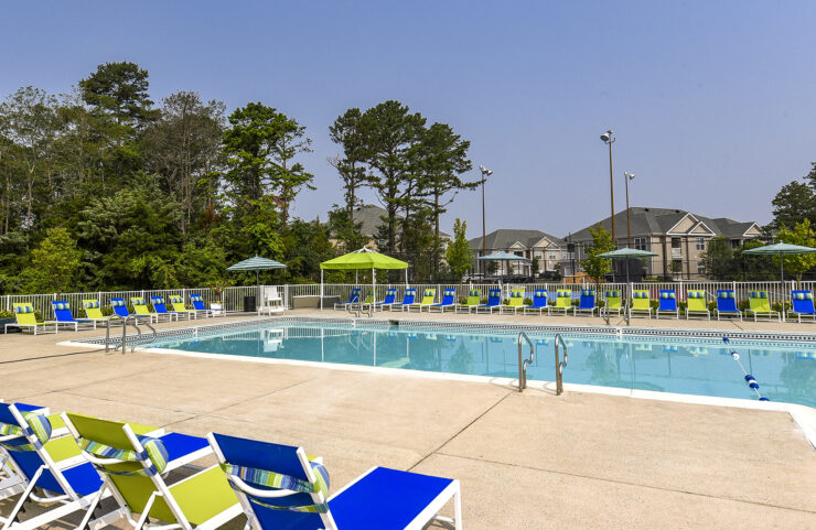 large outdoor pool with plenty of seating