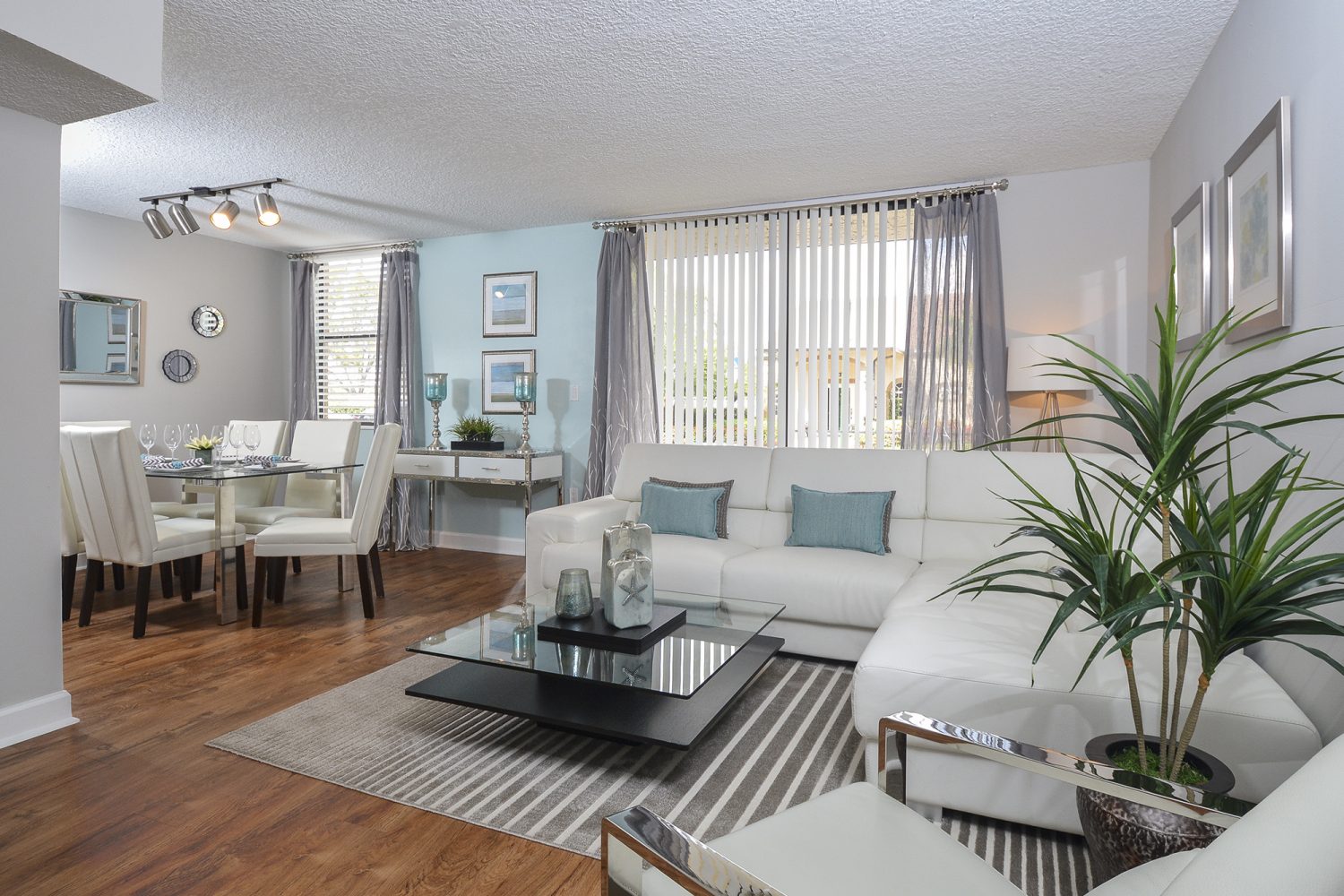 living room and dining room with plank flooring 