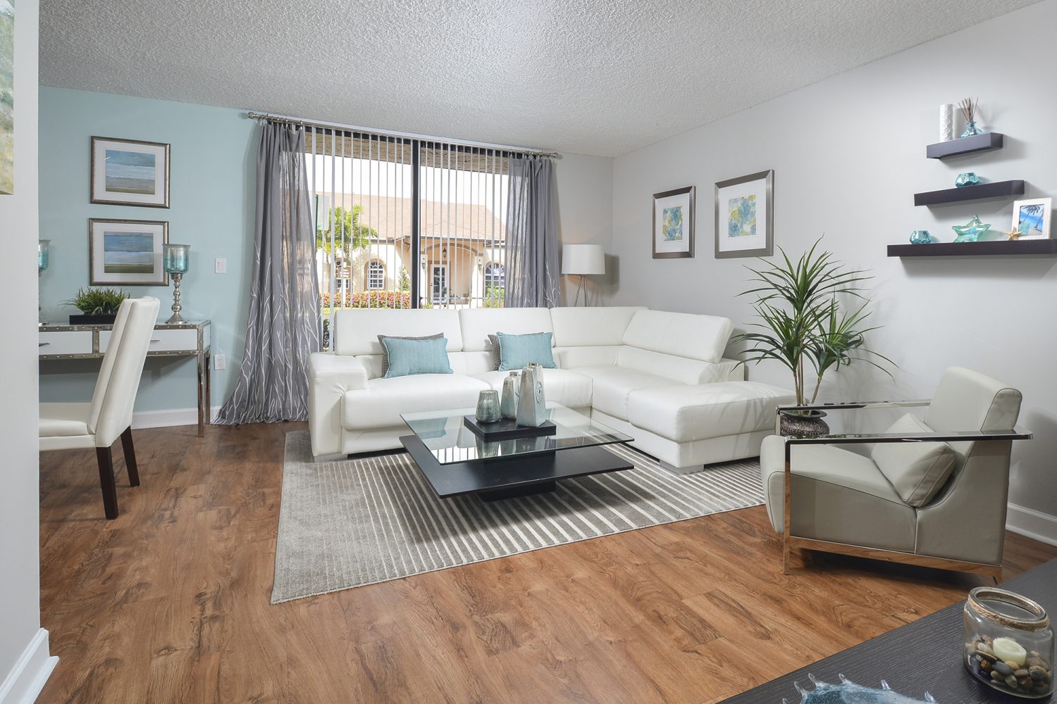 bright open living room with plank flooring 