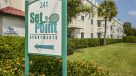 set point signage with apartments in the background