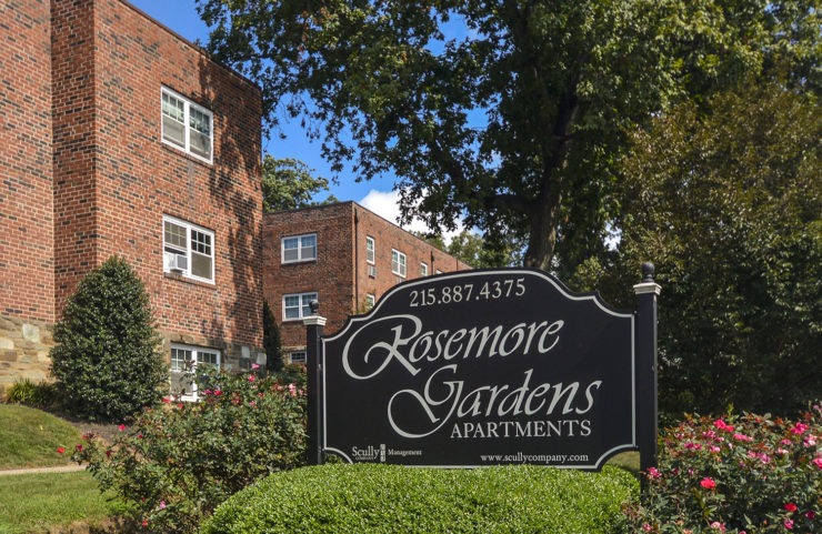 rosemore garden sign surrounded by pink flower bushes 
