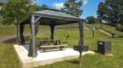 picnic bench under tent with grills 