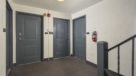 hallway showing apartment door entrances 