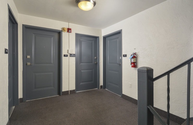 hallway showing apartment door entrances 