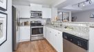 kitchen with white shaker cabinets and breakfast bar 