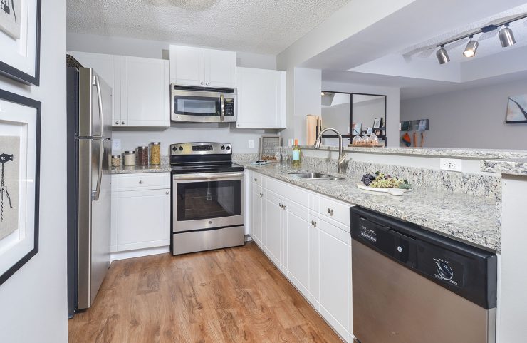 kitchen with white shaker cabinets and breakfast bar 