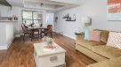 open layout living and dining area with hardwood floors 