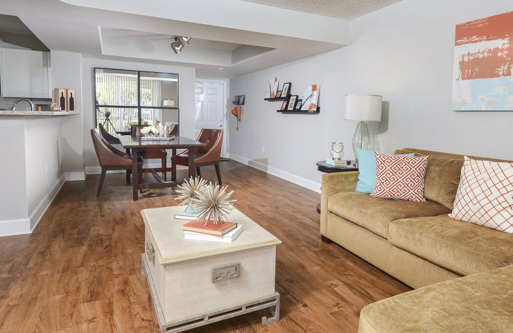 open layout living and dining area with hardwood floors 