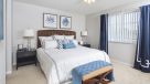 large bedroom with ceiling fans 