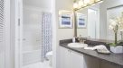 kitchen sink with vanity area outside the bathroom 