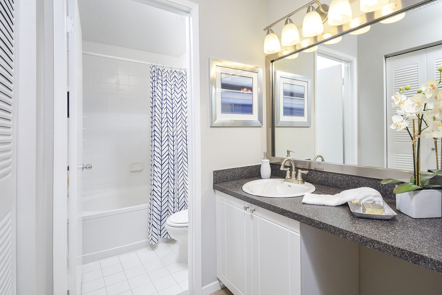 kitchen sink with vanity area outside the bathroom 
