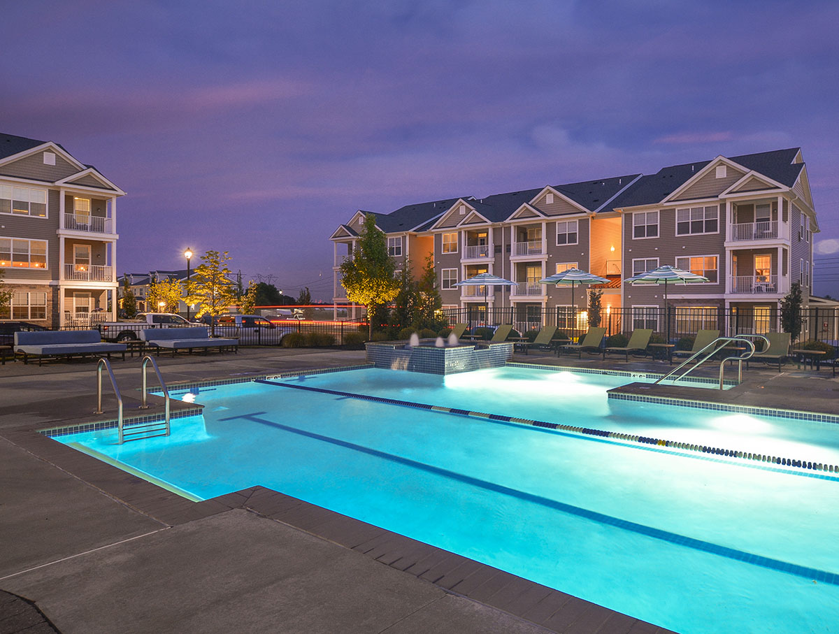 outdoor pool lit up at night 