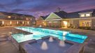 fountain and outdoor pool lit up at night 