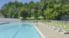 pool with lots of lounge chairs 