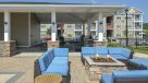 poolside firepit with cushioned patio furniture 