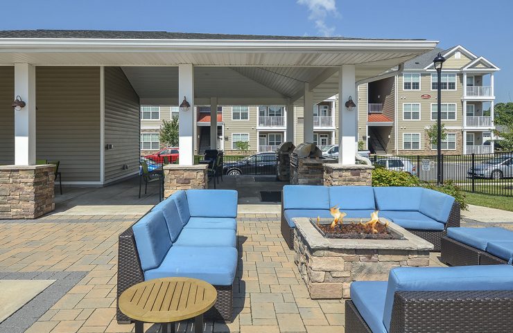 poolside firepit with cushioned patio furniture 