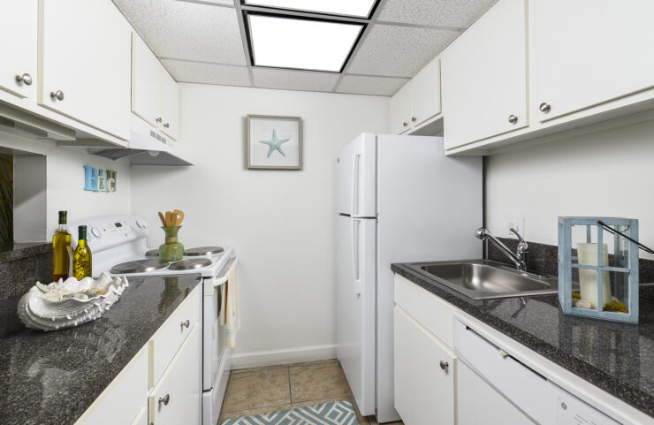 standard kitchen with white appliances and white cabinets