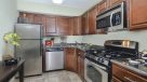 modern kitchen with medium wood cabinets and stainless steel appliance 