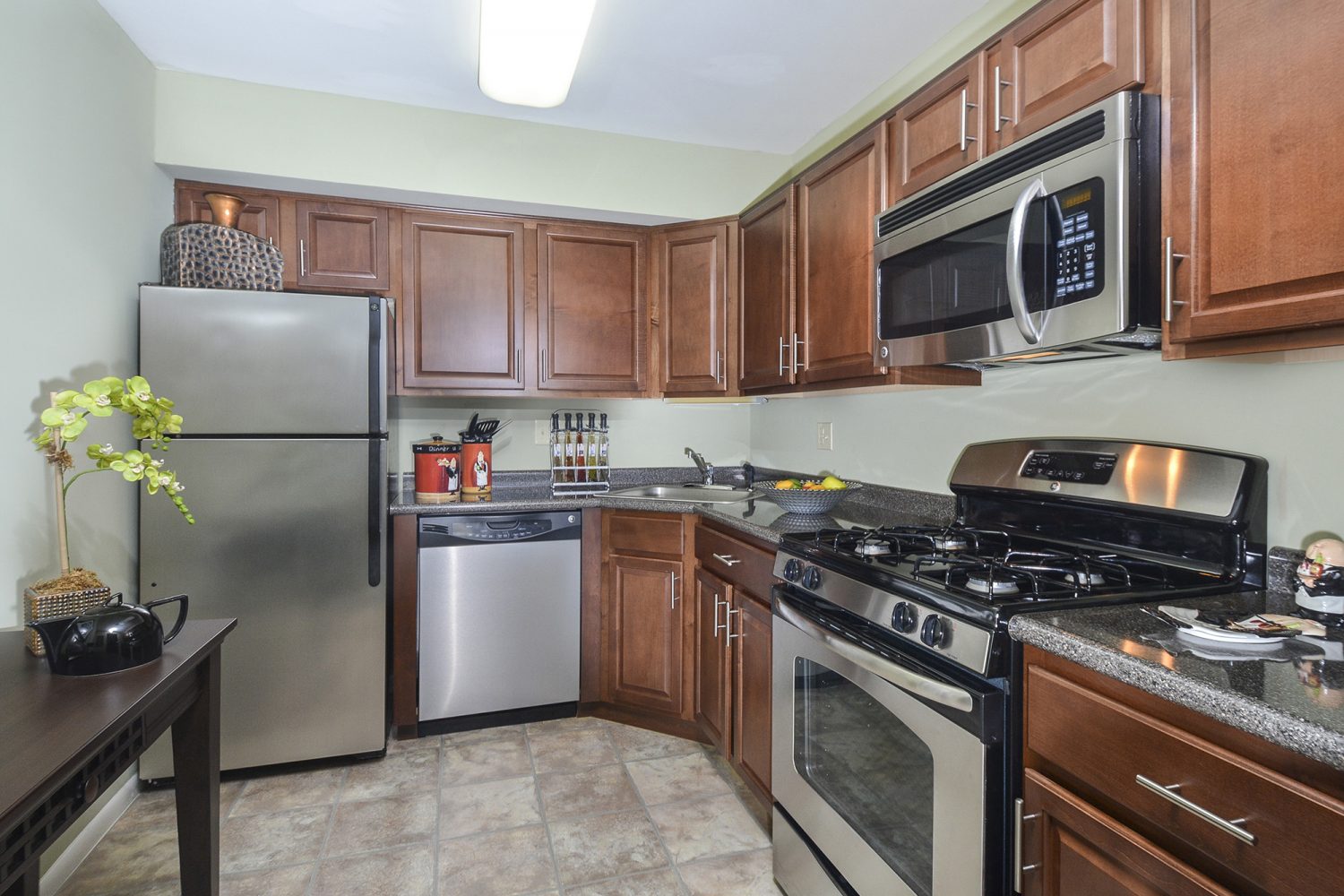 modern kitchen with medium wood cabinets and stainless steel appliance