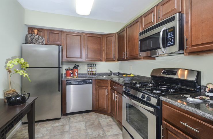 modern kitchen with medium wood cabinets and stainless steel appliance 
