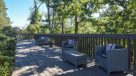 cushioned patio furniture on shaded deck 
