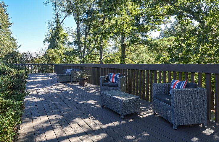 cushioned patio furniture on shaded deck 