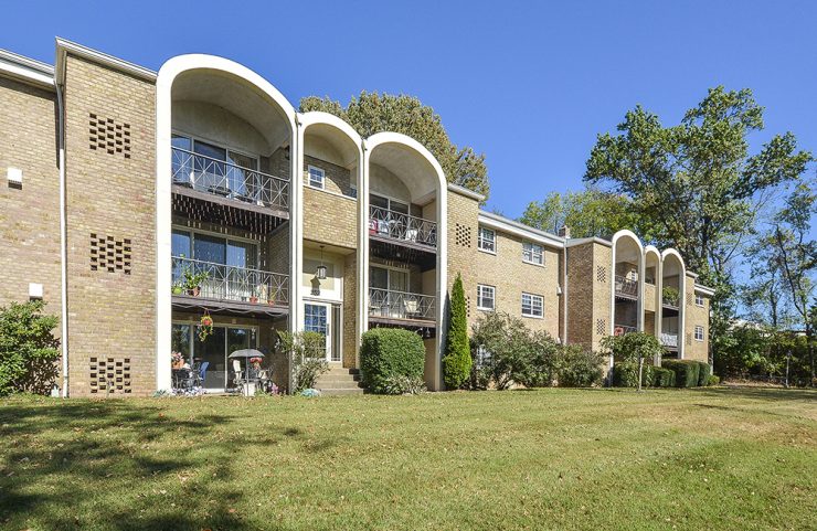 exterior facade with balconies and green grass 