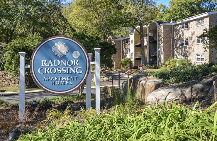 round blue radnor crossing sign at entrance of community 