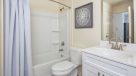 bathroom with white vanity and shower