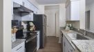 white kitchen cabinets, granite countertops and breakfast bar 