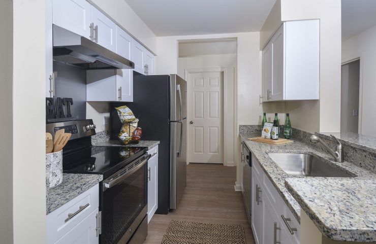 white kitchen cabinets, granite countertops and breakfast bar 
