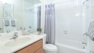bathroom with tile floor and tub 