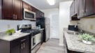 Galley style kitchen with stainless steel appliances and granite countertops