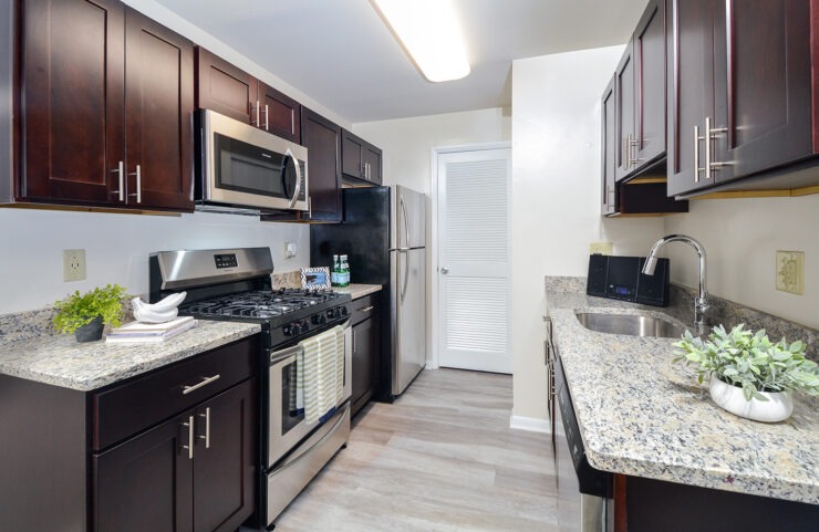 Galley style kitchen with stainless steel appliances and granite countertops