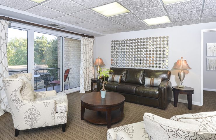 seating area with sofa and two chairs in the leasing office 