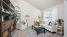 large living room with high ceilings and large windows