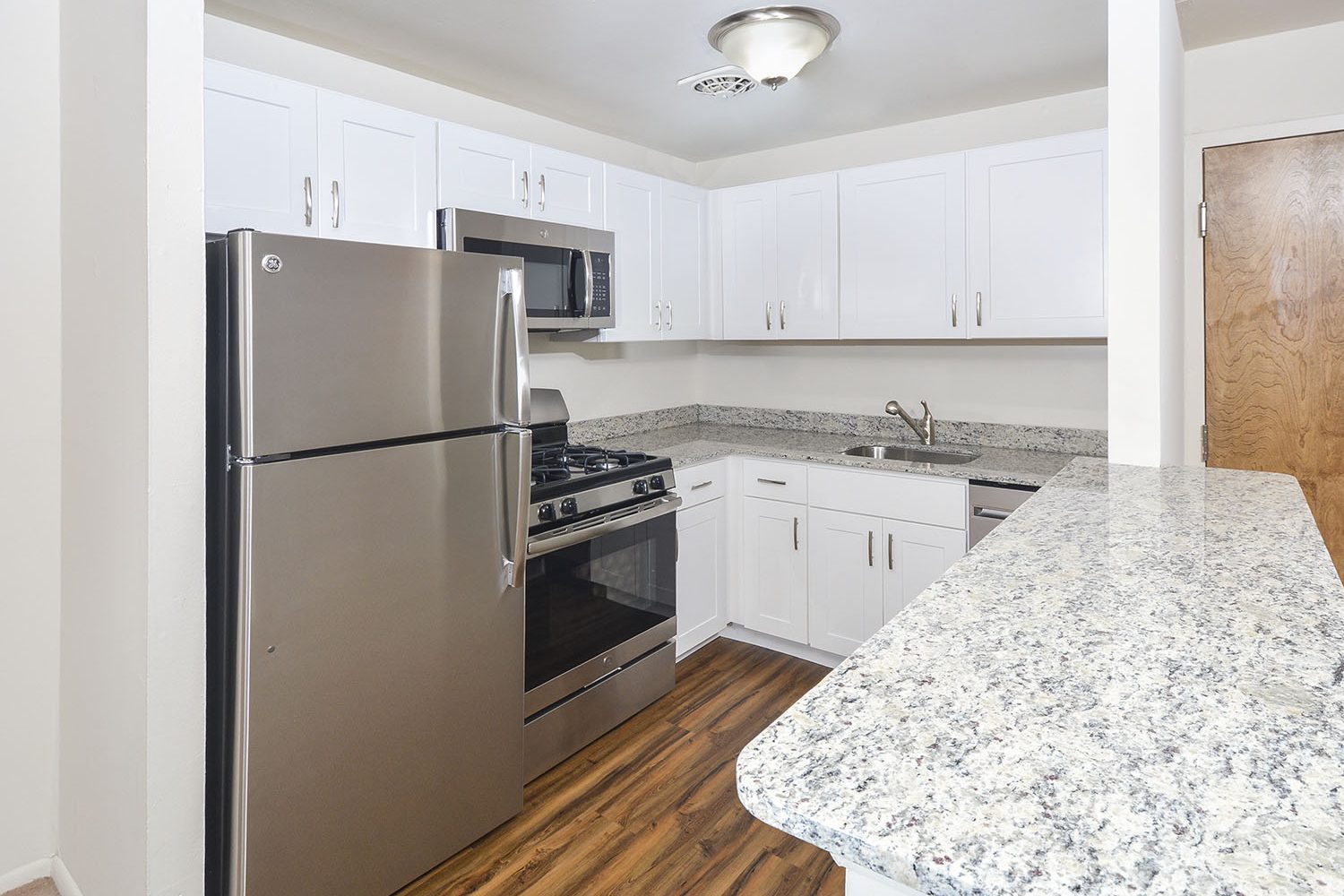 Kitchen with white cabinets and breakfast bar