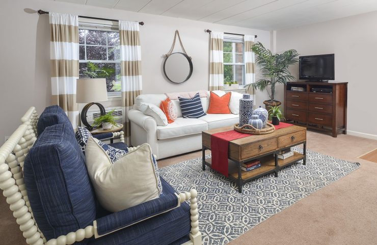 Living room with two large windows, sofa and two chairs 