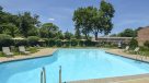 outdoor pool surrounded by lounge chairs and tables 