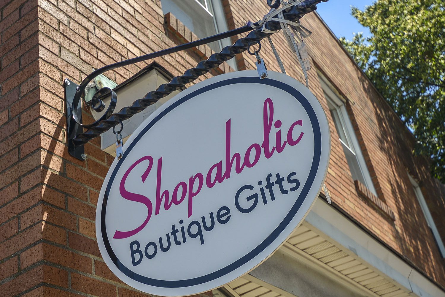 signage of Shopaholic Boutique located on main street