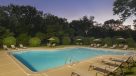 Outdoor Pool at Dusk with lounge chairs 