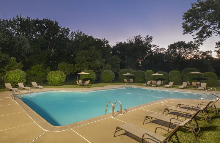 Outdoor Pool at Dusk with lounge chairs 