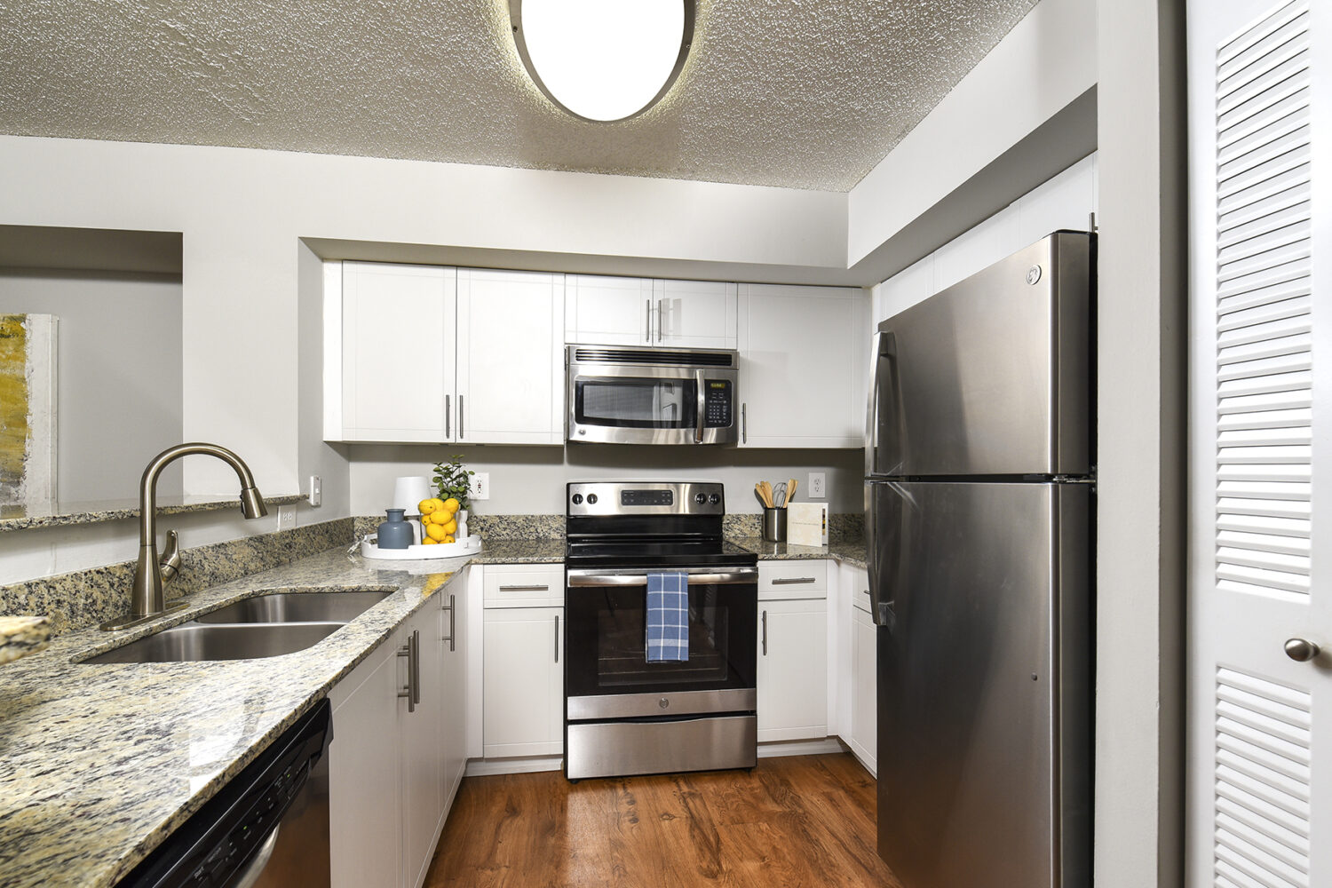 modern kitchen with white cabinets and stainless steel appliances
