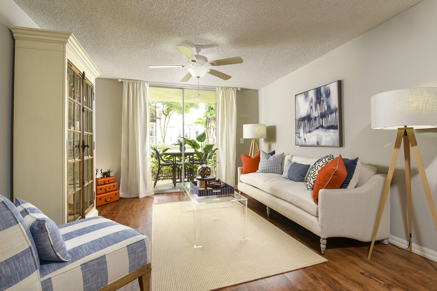 large living room with plank flooring and ceiling fan