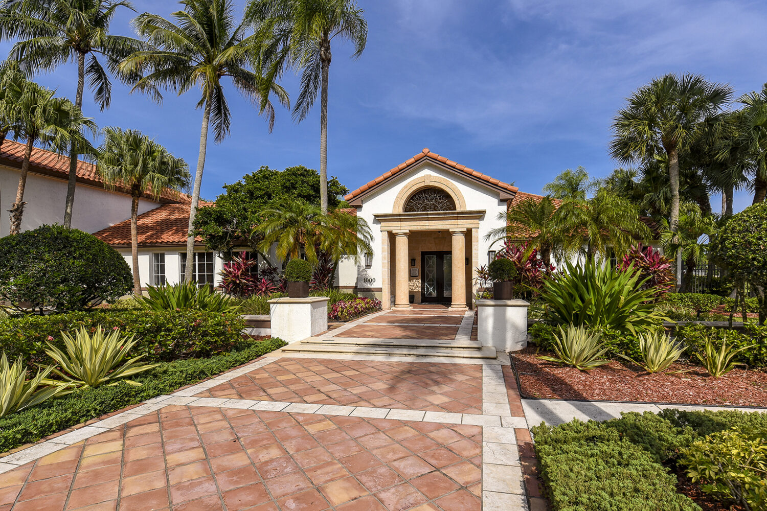 leasing office entrance with beautiful landscaping along walkway 