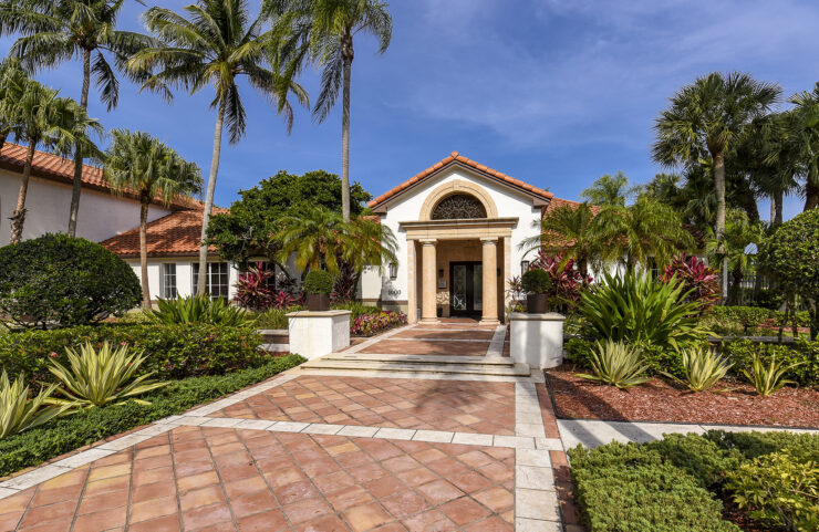 leasing office entrance with beautiful landscaping along walkway 
