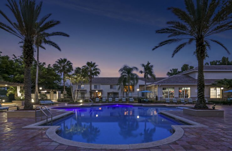 Pool at dusk with clubhouse views