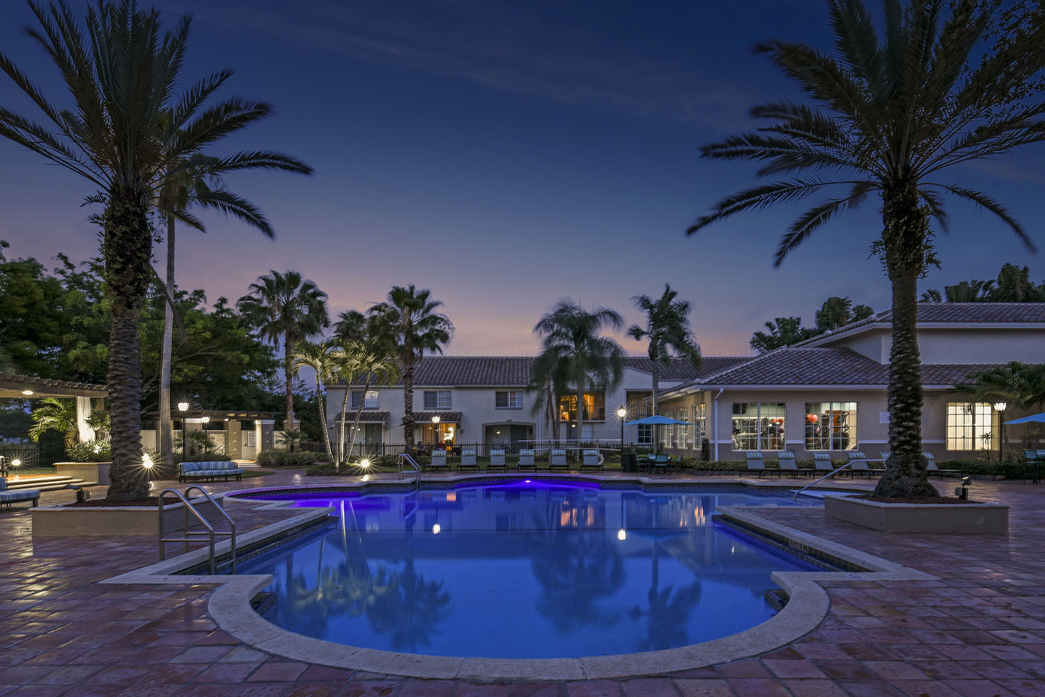 Pool at dusk with clubhouse views